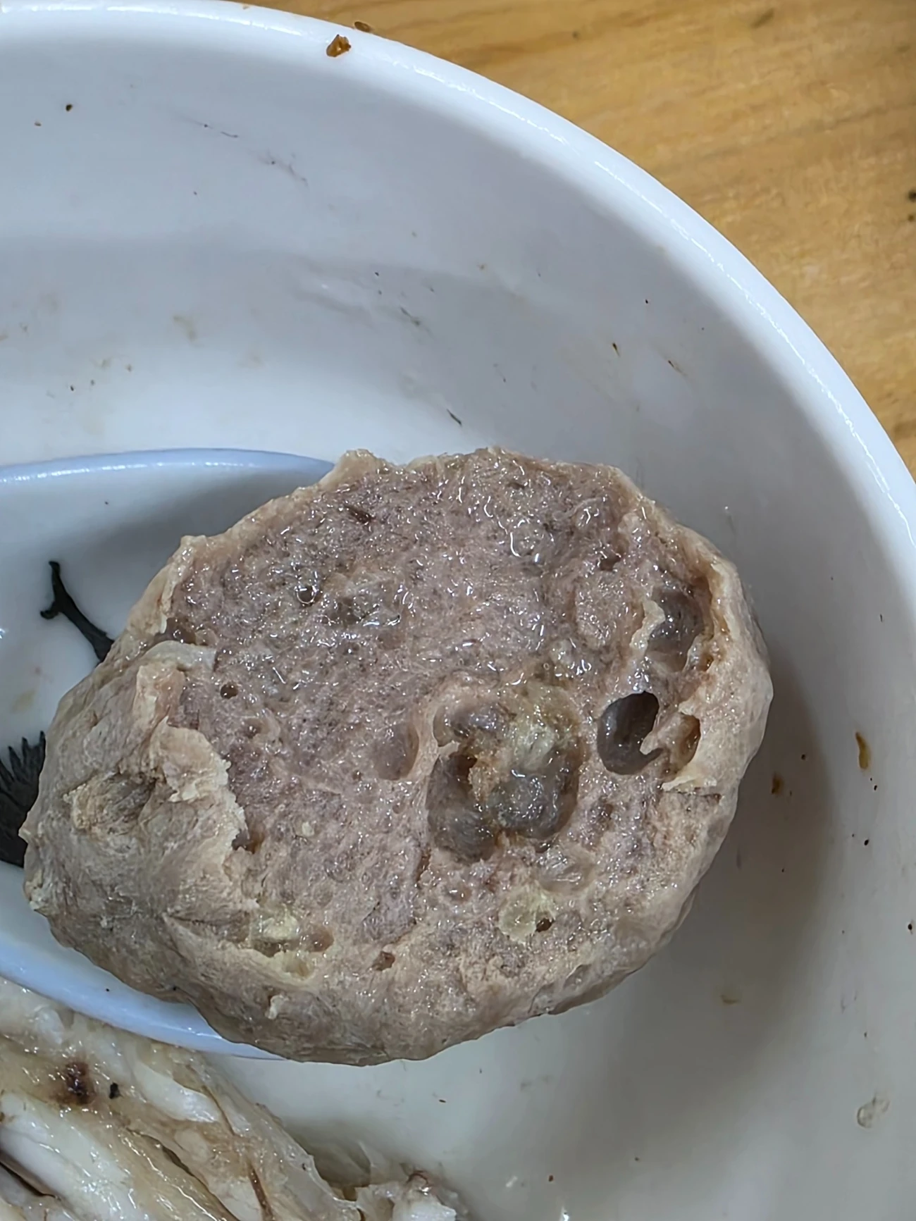 Real sample photograph showing the cut surface of a beef ball in a white bowl